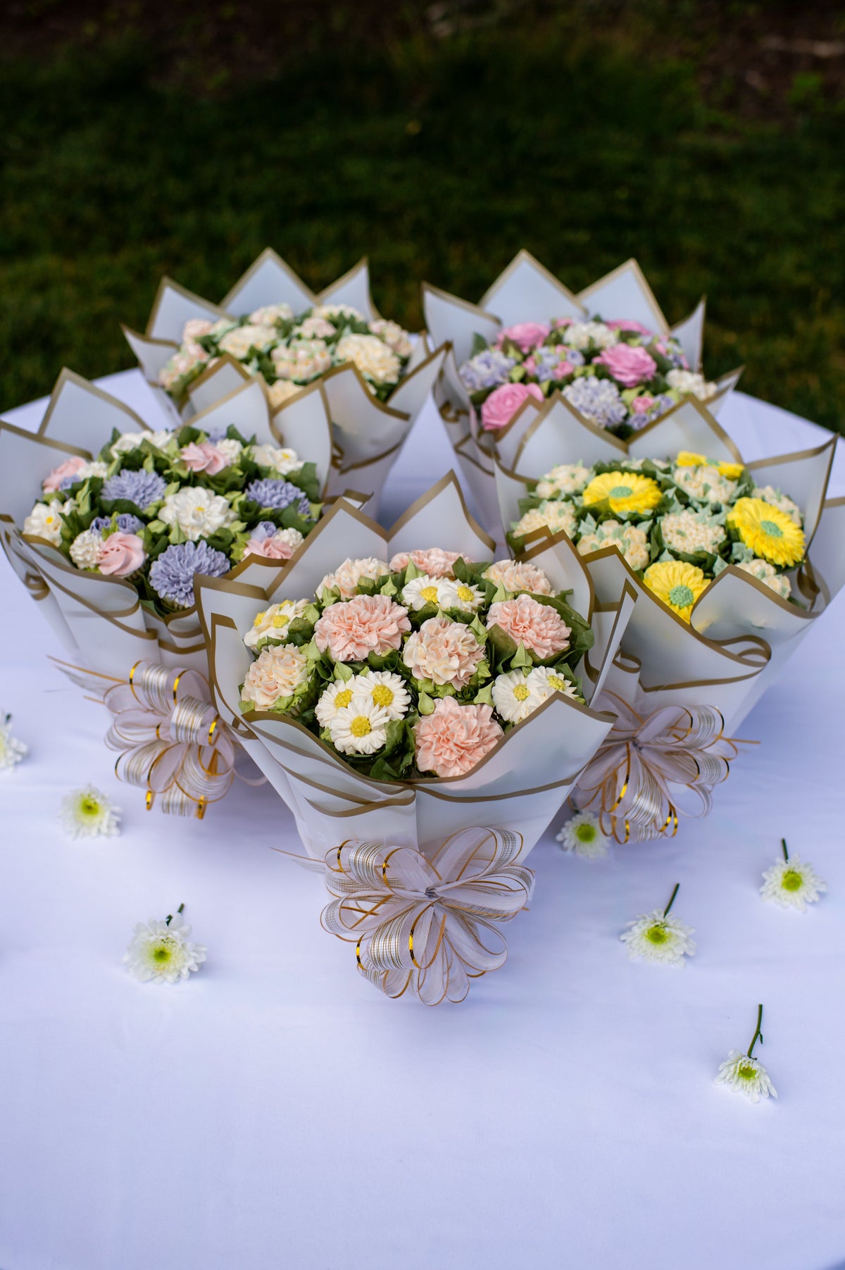 A collection of Butter Daisy floral cupcake bouquets